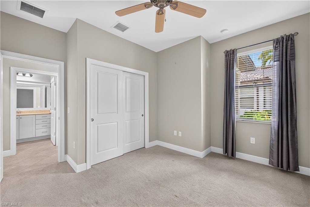 Bedroom featuring neutral wall colors, a ceiling fan, a window with blinds, drapes and a closet