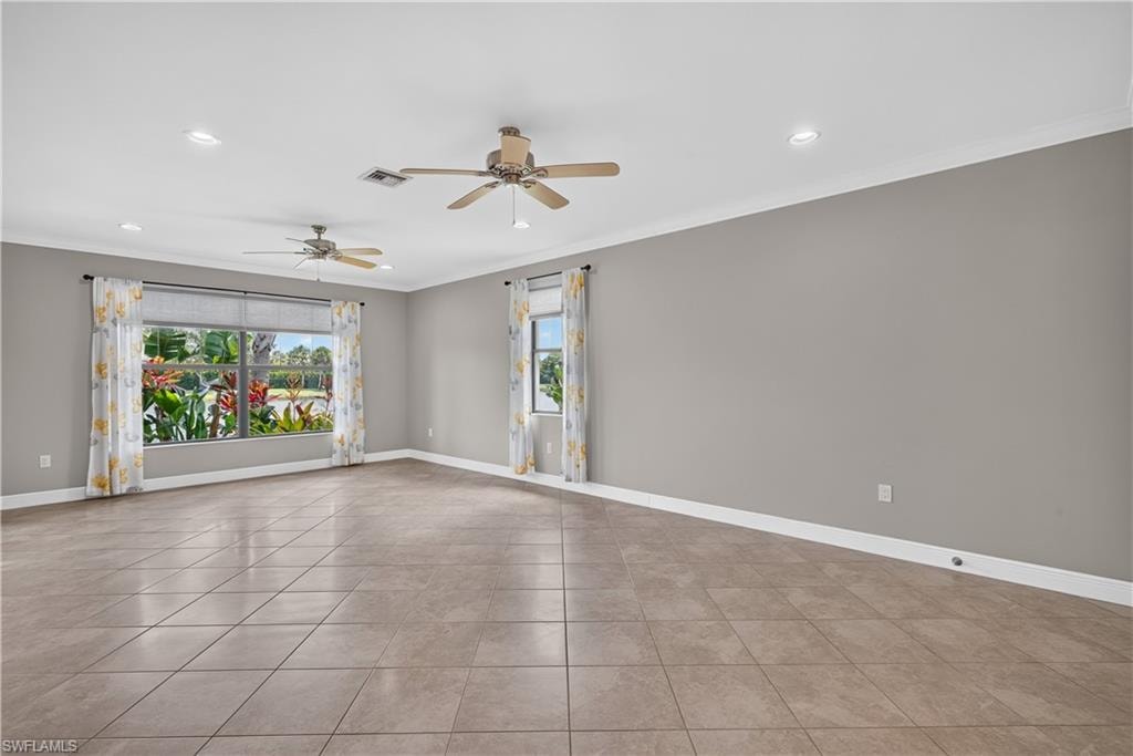 Living room with water views, upgraded tile floors, crown molding and 5 1/4" baseboards.