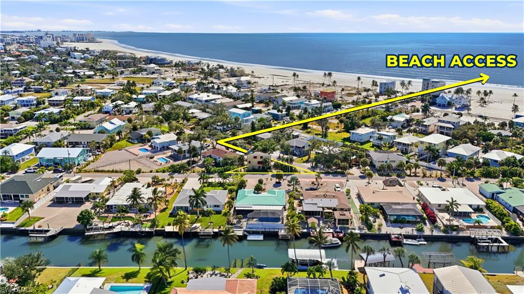 BEACH ACCESS - Aerial perspective of suburban area with unending shoreline - Virtually Edited Image