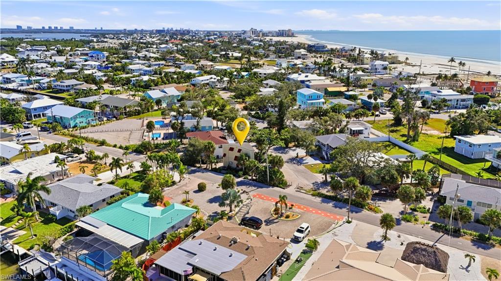 Aerial view of residential area featuring a nearby body of water - Virtually Edited Image