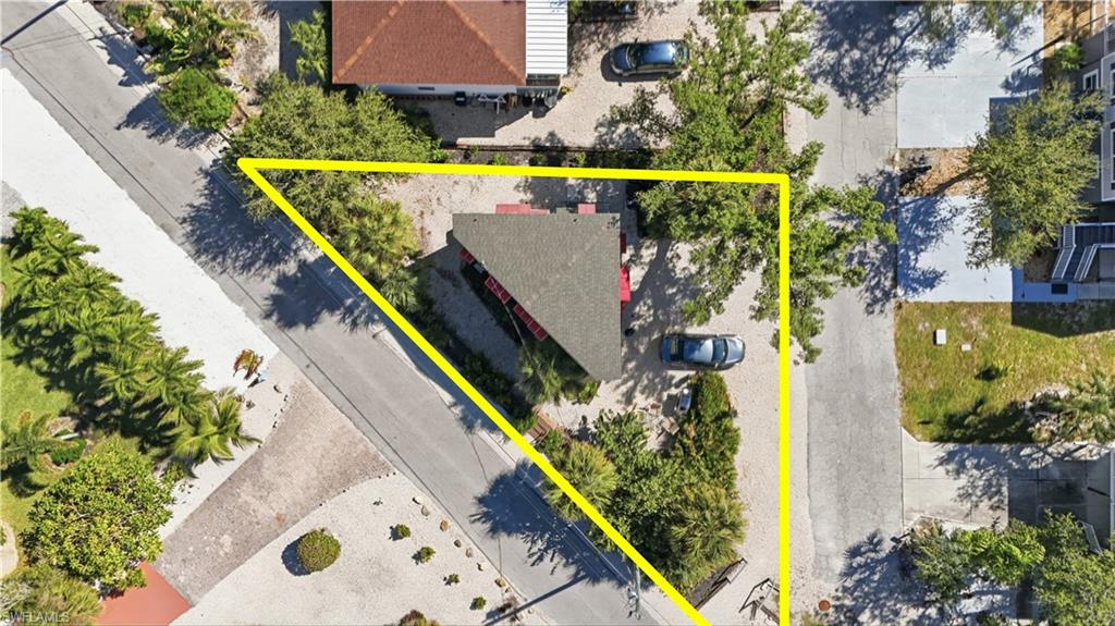 Aerial view of property and surrounding area featuring property boundaries highlighted - Virtually Edited Image
