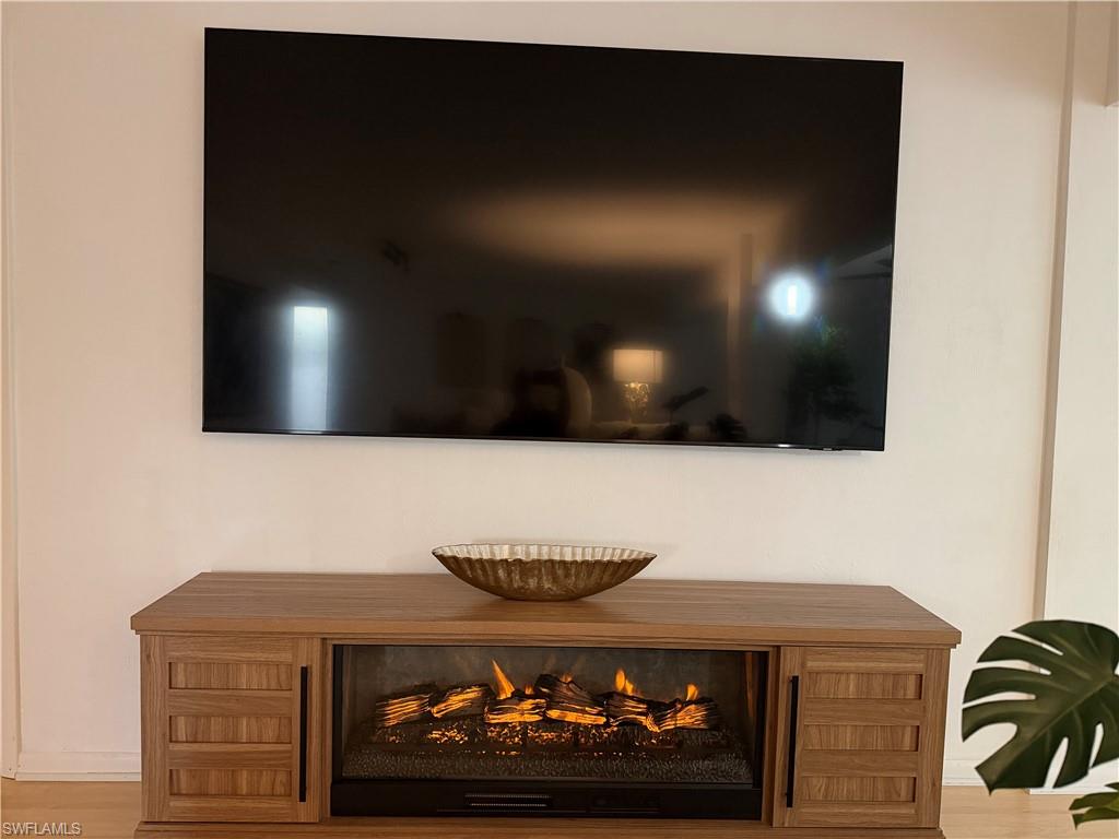 Wood-finish media console with an integrated electric fireplace