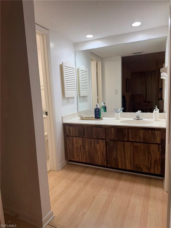 Double vanity with undermount sinks, light countertop, and rich wood-finish cabinetry