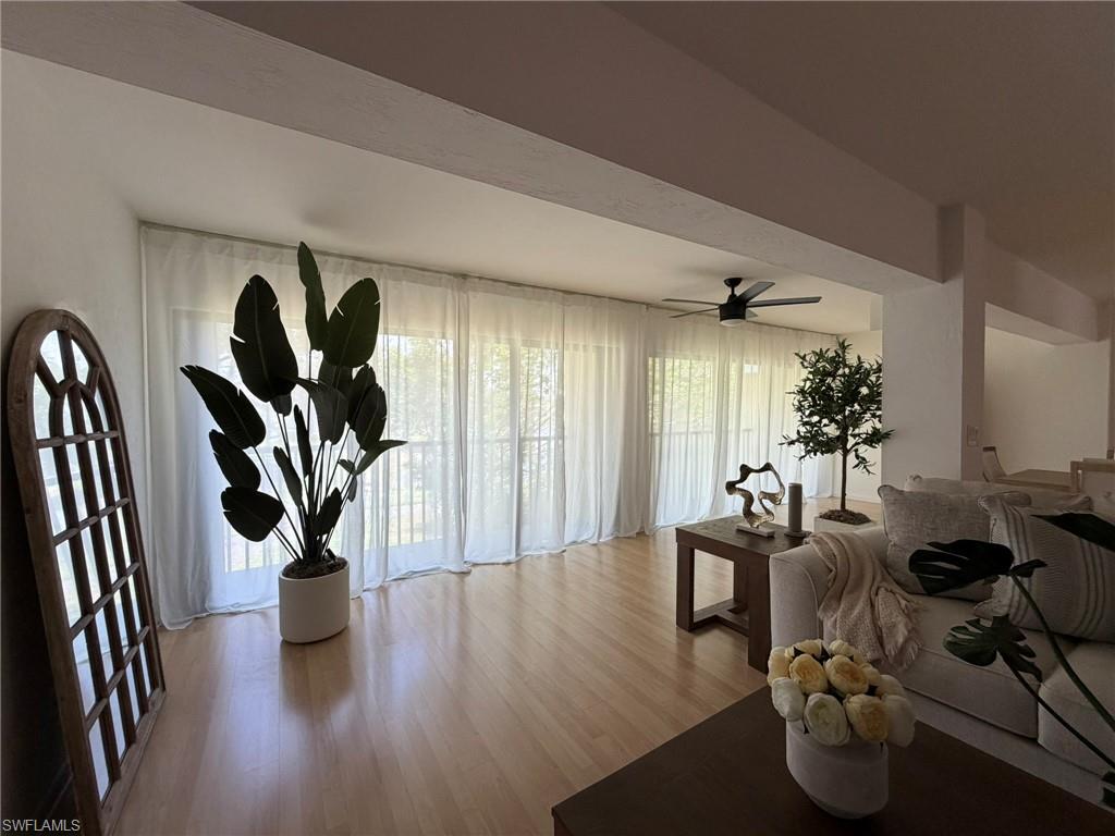 Light wood-finish flooring extends through this open-concept living space