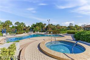 Outdoor amenity area featuring a curvilinear swimming pool and an integrated spa