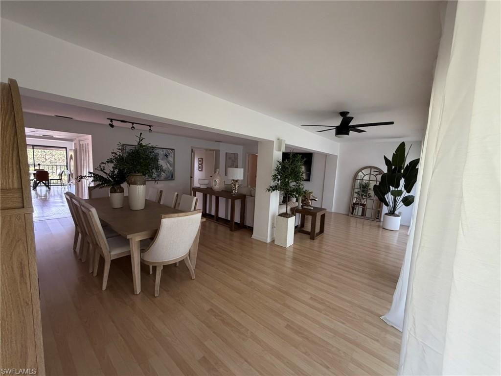 Open-concept living area featuring light wood-finish flooring, recessed lighting, and a contemporary ceiling fan