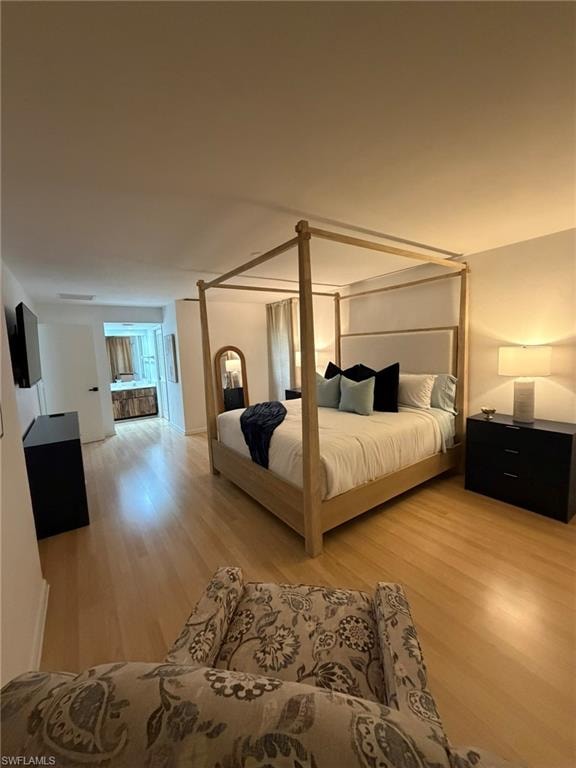 Light wood-finish flooring extending throughout the room