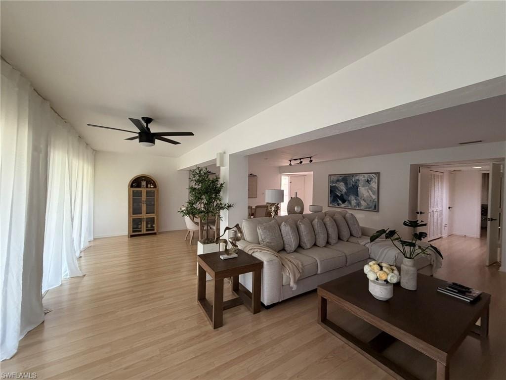 Bright interior featuring wood-finish flooring, recessed lighting, and a contemporary ceiling fan