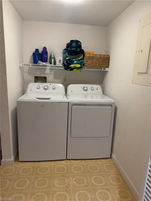 Dedicated laundry area featuring a washer and dryer, patterned floor tile, and overhead wire shelving for storage