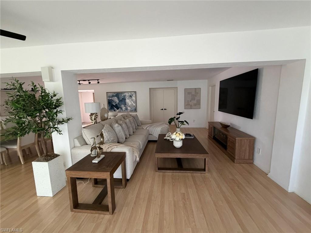 Open concept living area featuring light wood-finish flooring, a contemporary ceiling fan, and recessed lighting