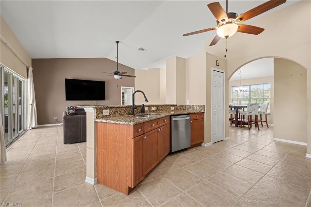 Kitchen island featuring granite countertops and wood cabinetry