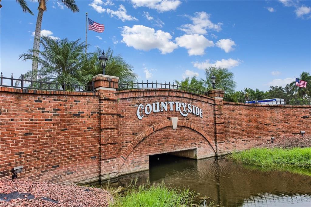 Community / neighborhood sign featuring a water view