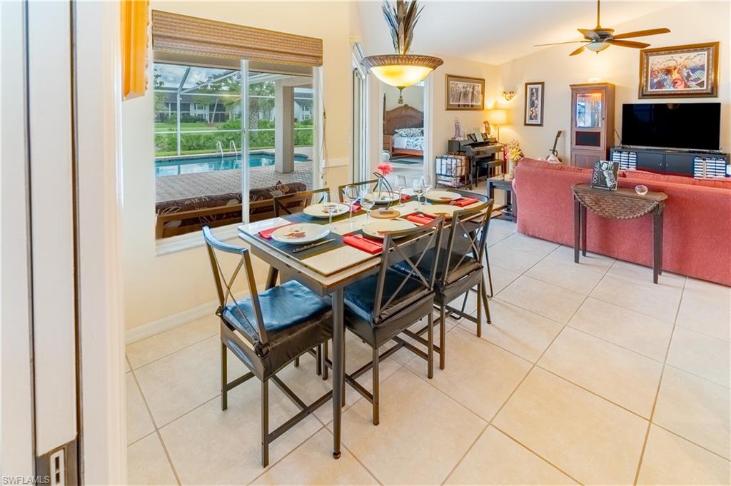 Dining room with light tile patterned floors, a ceiling fan, and a sunroom