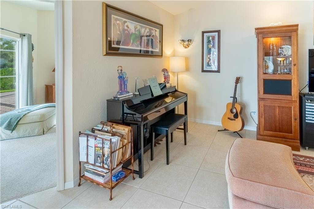 Living area featuring light tile patterned flooring and wine cooler