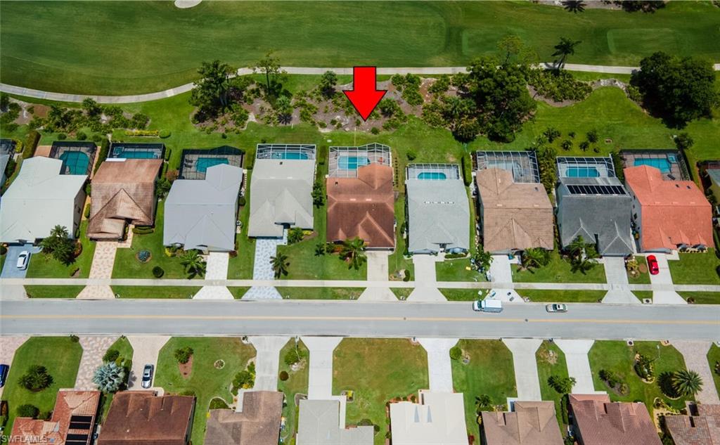 Aerial perspective of suburban area featuring a local golf course