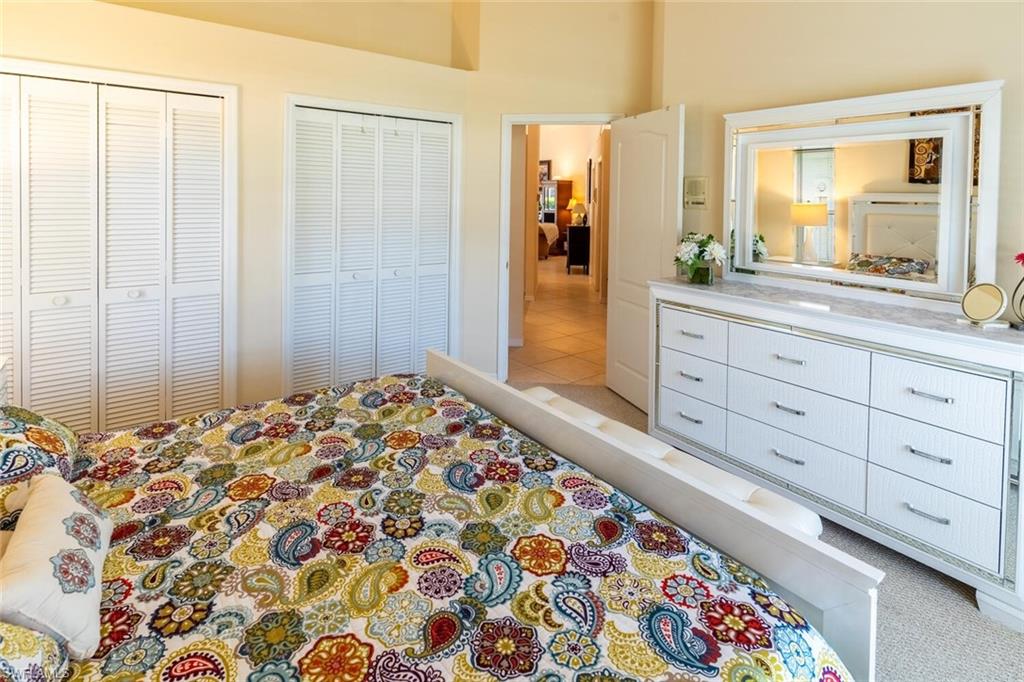 Bedroom featuring multiple closets and light tile patterned flooring