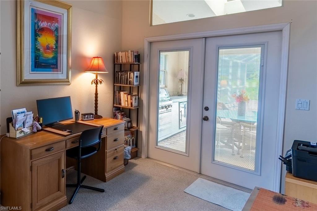 Office space featuring french doors, light colored carpet, and healthy amount of natural light