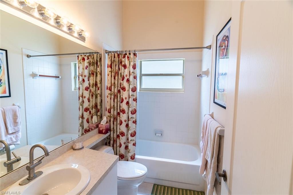 Full bathroom featuring shower / bathtub combination with curtain and vanity