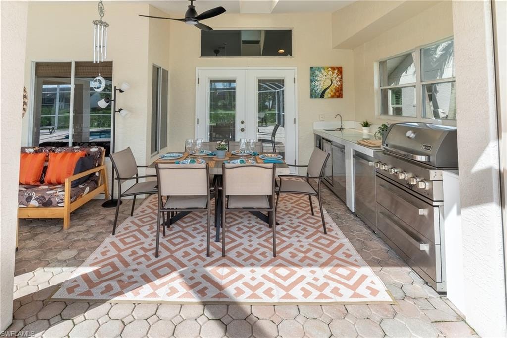 View of patio / terrace featuring outdoor dining area, ceiling fan, french doors, and area for grilling