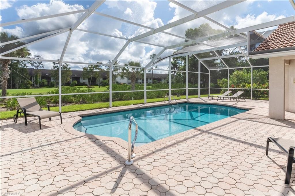 Outdoor pool featuring a patio, a lanai, and a sunroom