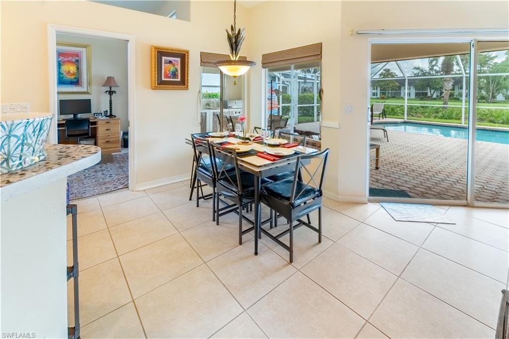 Dining space featuring light tile patterned floors, a sunroom, and an office area