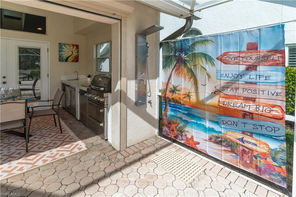 View of patio / terrace with an outdoor kitchen and a sink