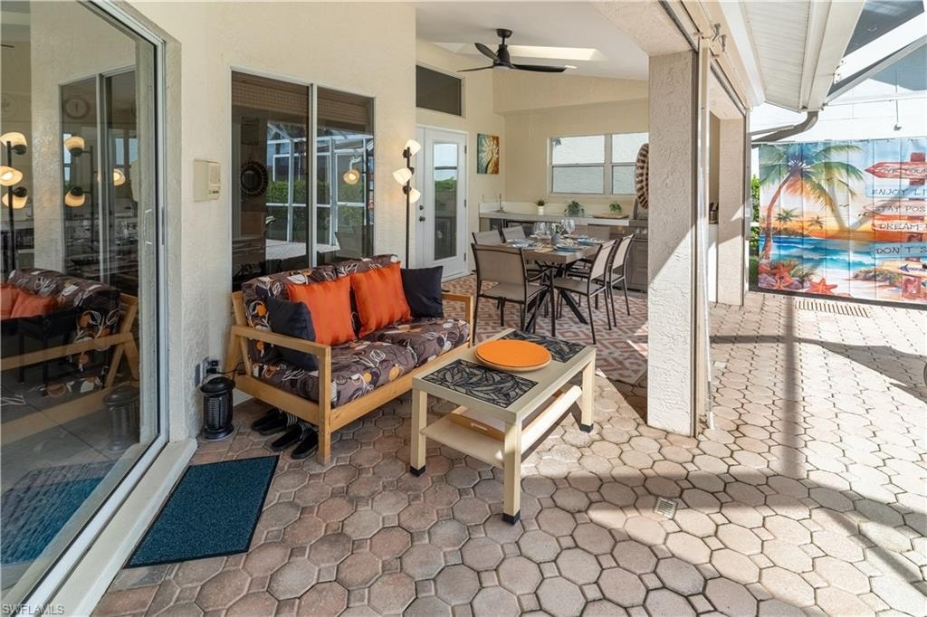 View of patio / terrace featuring outdoor dining area, ceiling fan, and an outdoor hangout area