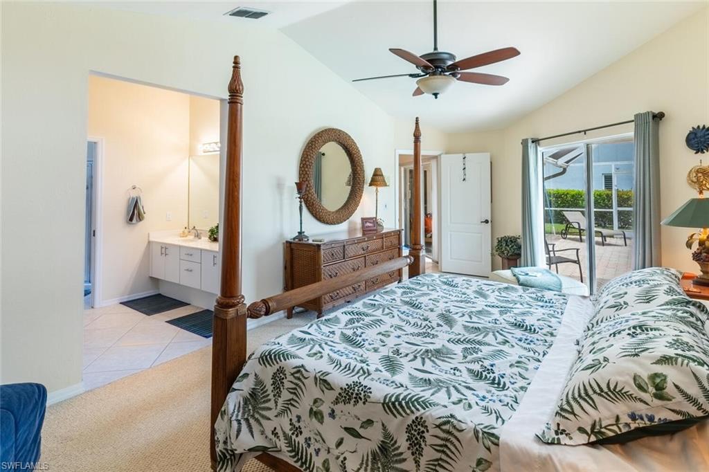 Bedroom featuring lofted ceiling, access to exterior, light carpet, a ceiling fan, and light tile patterned floors