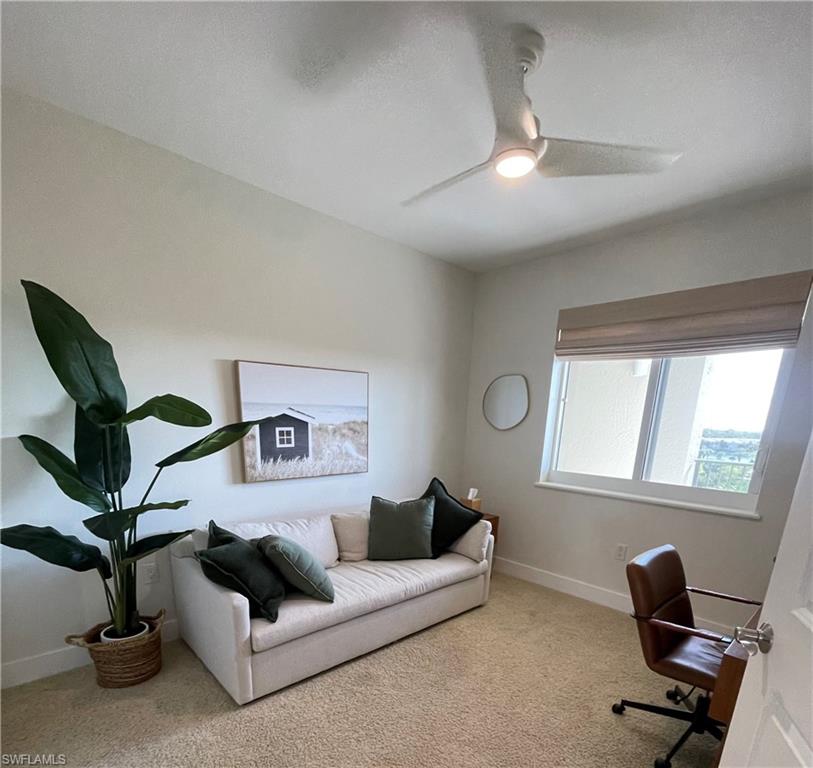Carpeted office with ceiling fan and a textured ceiling