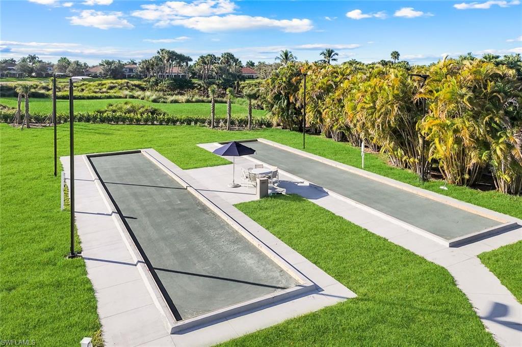 Two bocce ball courts set within a manicured lawn area