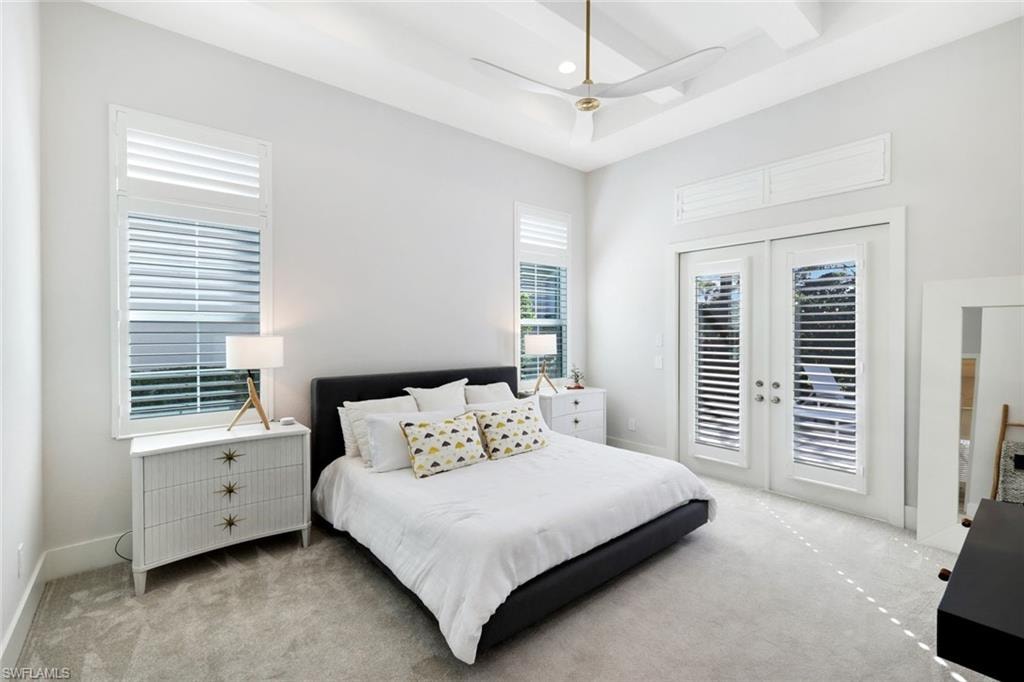 Spacious room featuring a tray ceiling with a modern ceiling fan and recessed lighting
