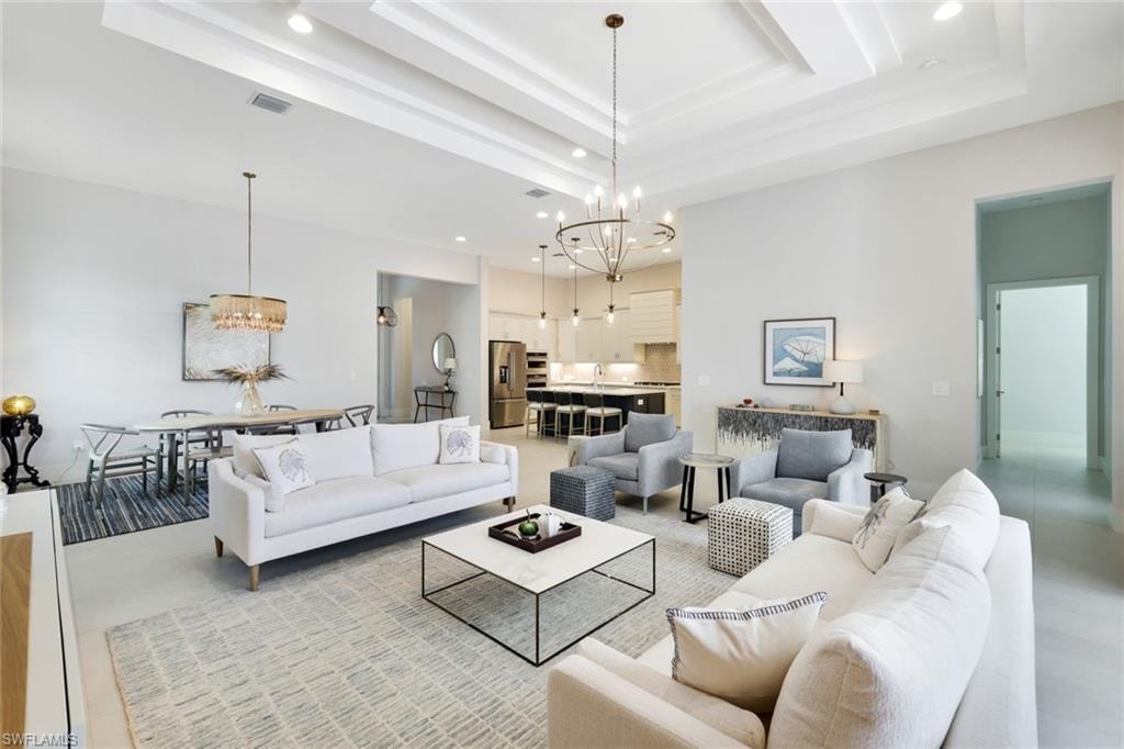 Expansive open-concept living area featuring a coffered ceiling and recessed lighting