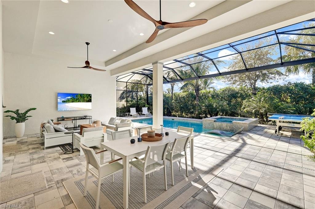 Expansive screened lanai featuring a swimming pool, integrated spa, and textured tile flooring