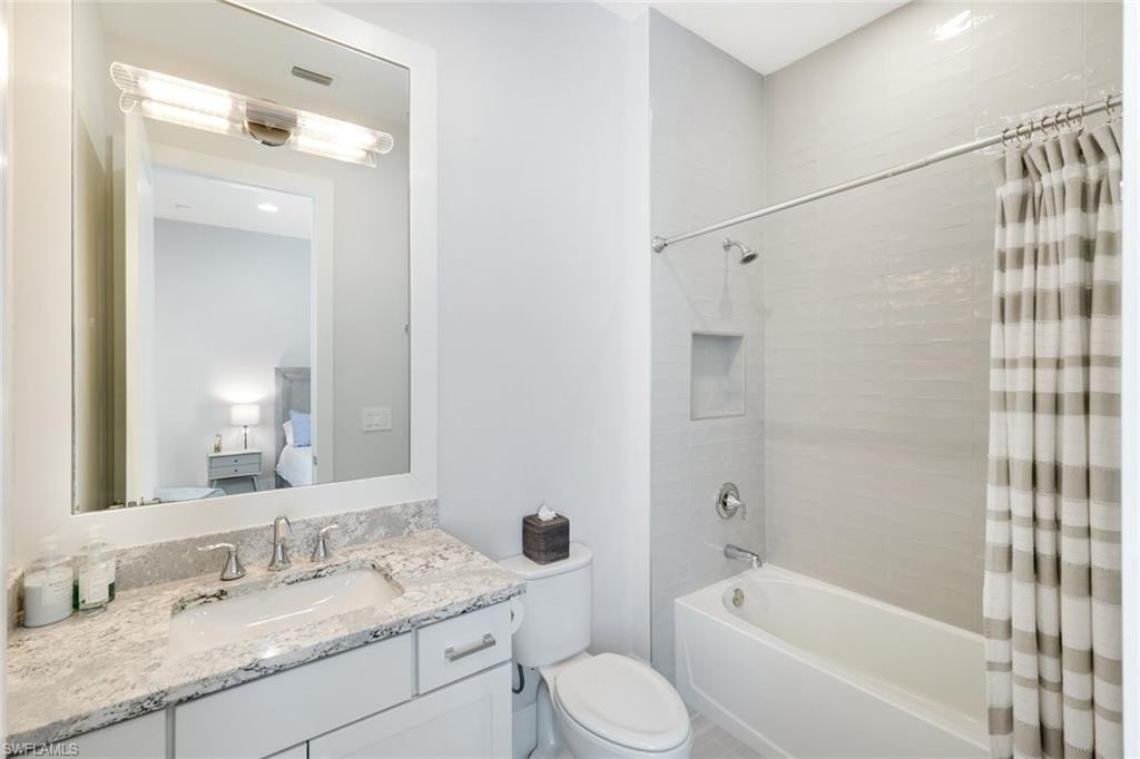 Contemporary bathroom featuring a single vanity with granite countertop, undermount sink, and chrome fixtures