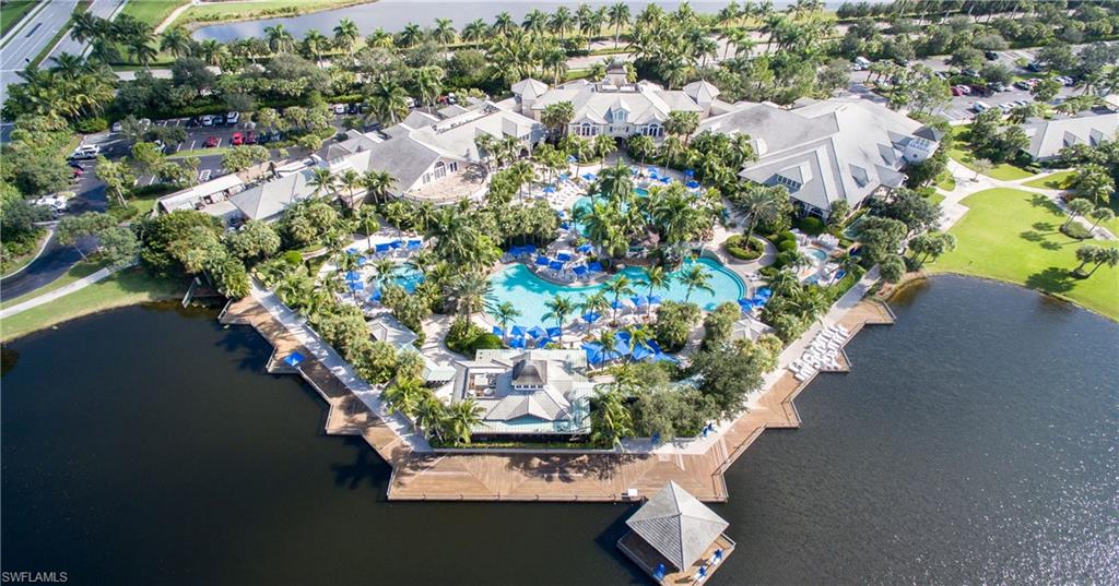 Expansive resort-style complex featuring multiple swimming pools, extensive decking, and mature tropical landscaping