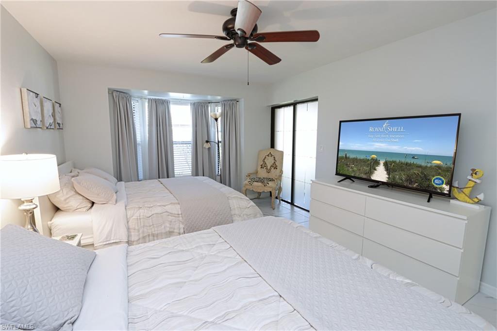 Bedroom with multiple windows and ceiling fan