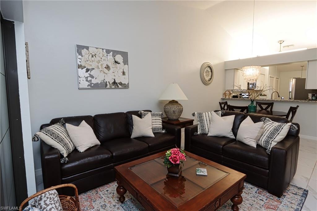 Tiled living room featuring lofted ceiling