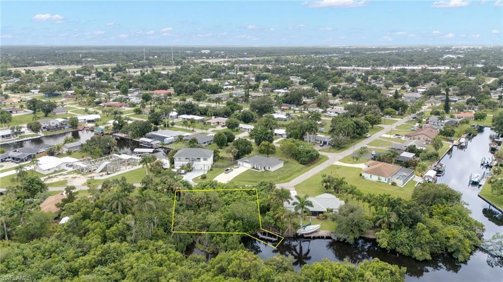 Waterfront parcel with direct canal access, surrounded by mature trees