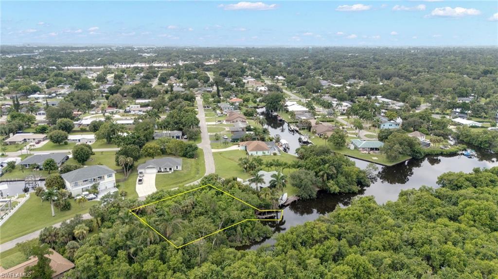 Canal-front property featuring extensive natural vegetation and a private dock