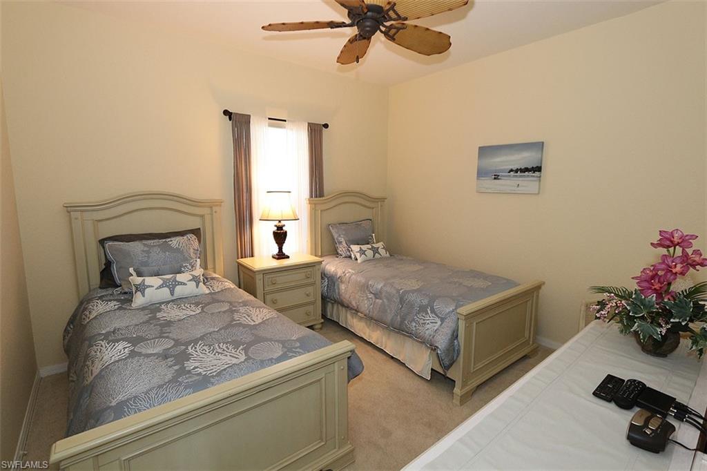 Bedroom featuring ceiling fan and light carpet