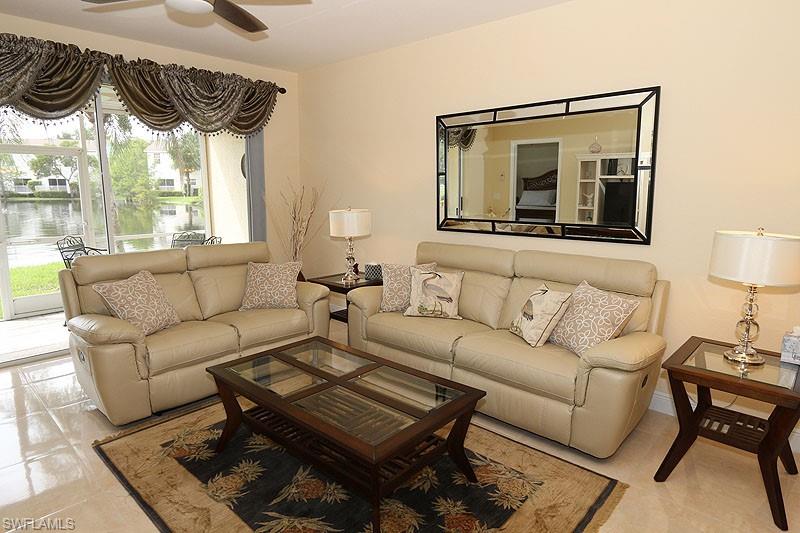 Living room featuring ceiling fan and light tile floors