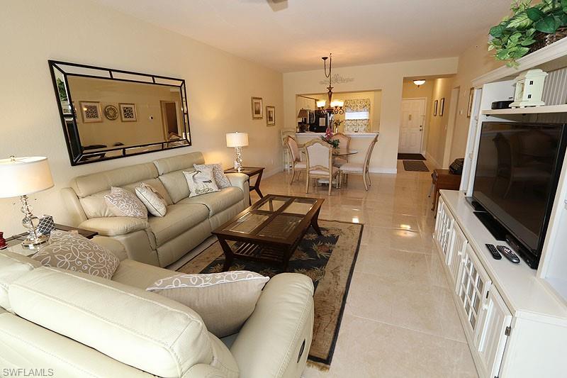 Living room with a notable chandelier and light tile floors