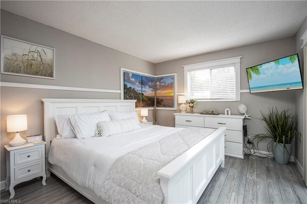 Bedroom featuring a textured ceiling and wood finished floors