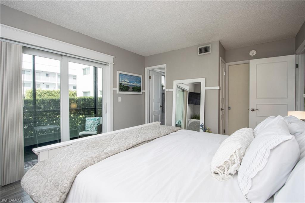 Bedroom featuring a textured ceiling and wood-type flooring