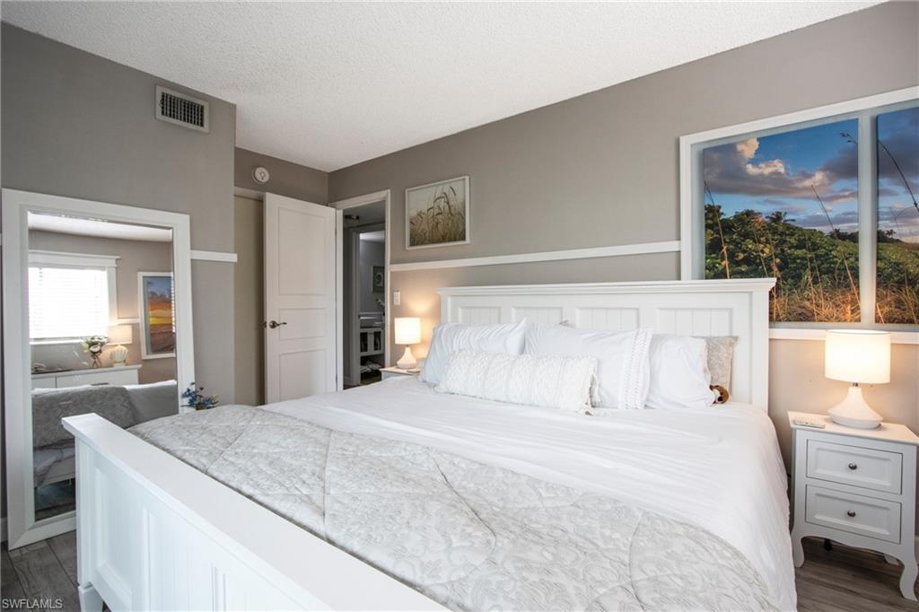 Bedroom featuring a textured ceiling and dark wood-type flooring