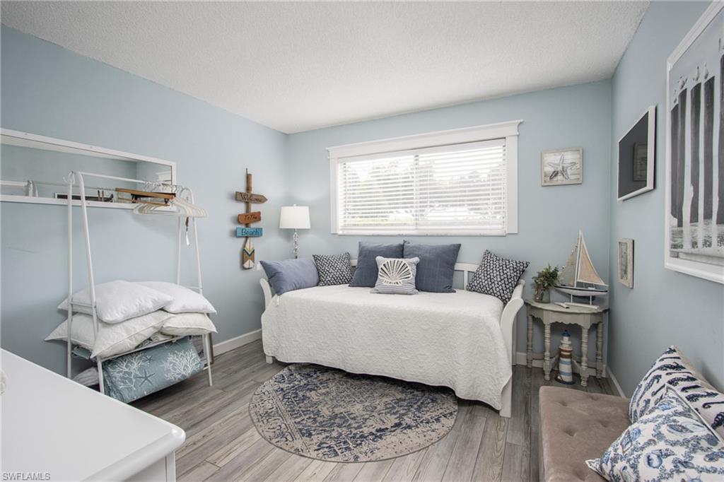 Bedroom with a textured ceiling and hardwood / wood-style flooring
