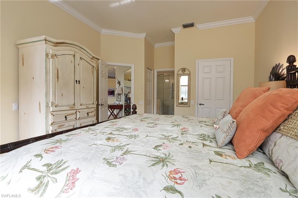 Bedroom with ensuite bath and crown molding