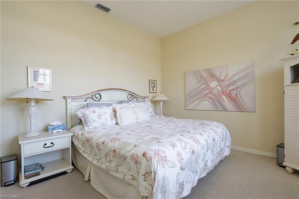 Carpeted bedroom featuring baseboards