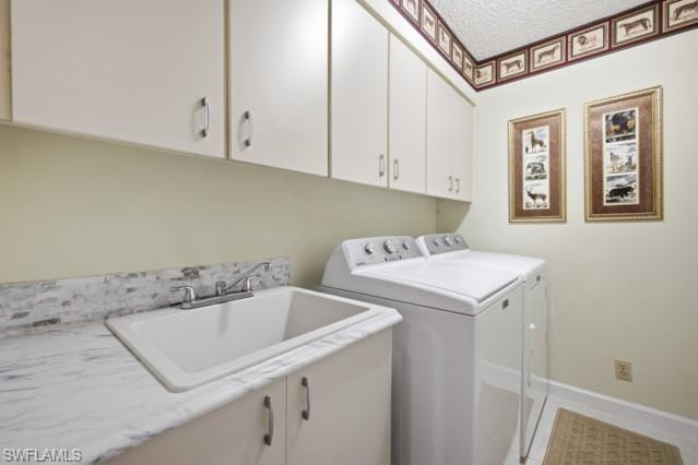 Utility room featuring a built-in sink, white cabinetry, a marble-look countertop, and a tile backsplash