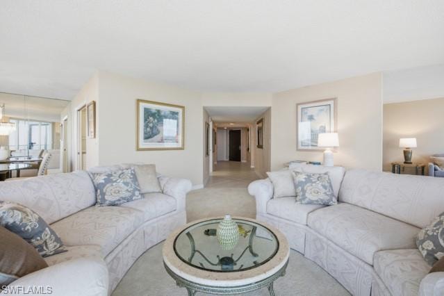 Expansive living area featuring light-toned walls and carpet flooring